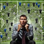 Generate a realistic high definition image that depicts an anxious football manager surrounded by various strategies, tactics, and formations as he faces a challenging decision in the midfield ahead of a crucial match.