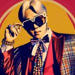 Generate an image presenting a triumphant return of a skilled South Korean rapper with his new single titled 'POWER'. This individual is lavishly dressed, known for his bold and fashion-forward style. Please include the title 'POWER' in a catchy font.